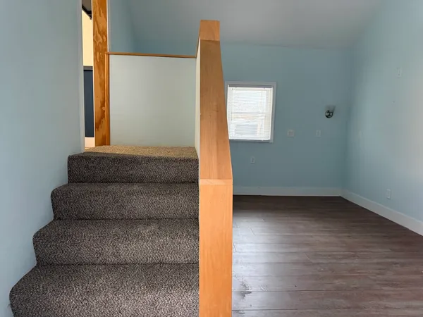 a view of an entryway with wooden floor