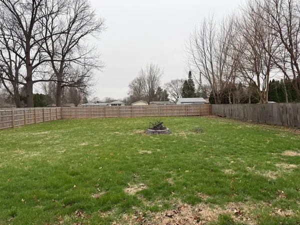 a backyard of apartments with large trees