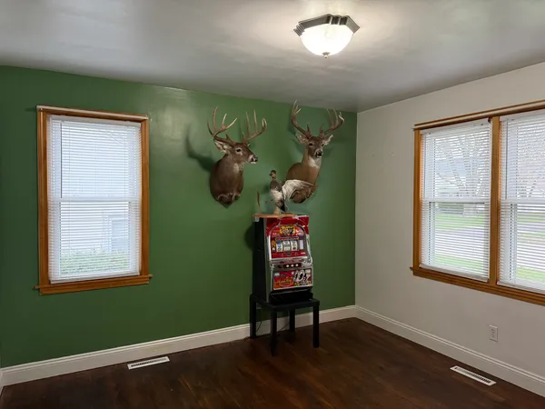 a view of a room with windows and wooden floor