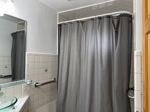 a bathroom with a shower and a sink