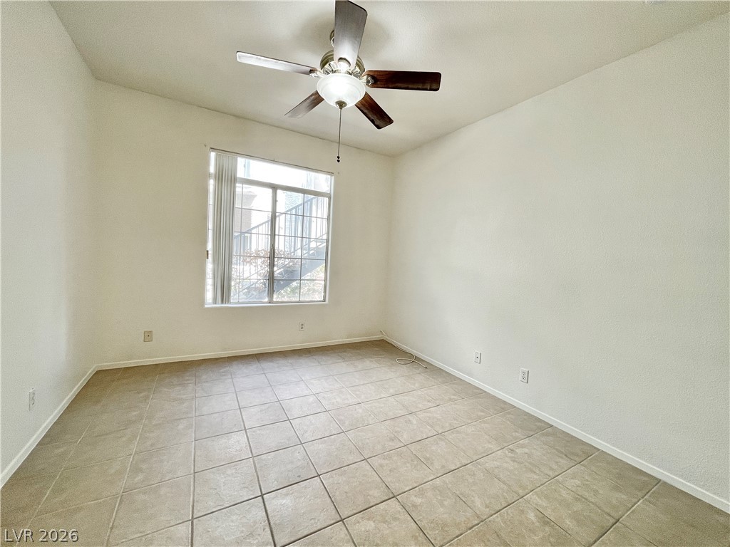 2201 Ramsgate Drive, Unit 915 Henderson, NV 89074 - Photo 28 of 36 A well-lit room featuring durable tile flooring and a ceiling fan for comfort.