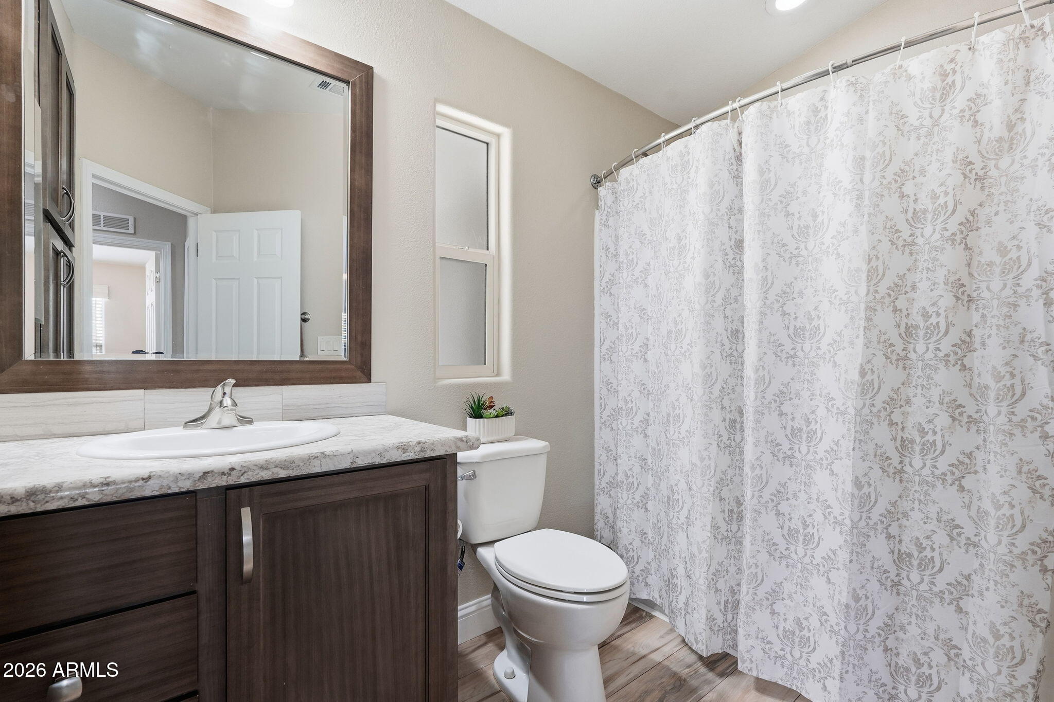8865 East Baseline Road, Unit 1417 Mesa, AZ 85209 - Photo 24 of 47 a bathroom with a granite countertop sink and a mirror