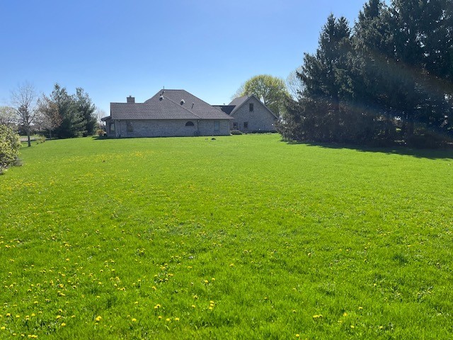 927 Dickson Road Bristol, IL 60560 - Photo 6 of 9 a view of a house with a yard and a large tree