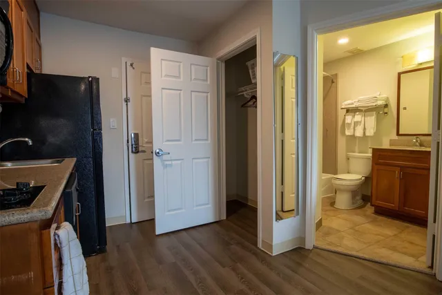 a bedroom with two beds and a dresser