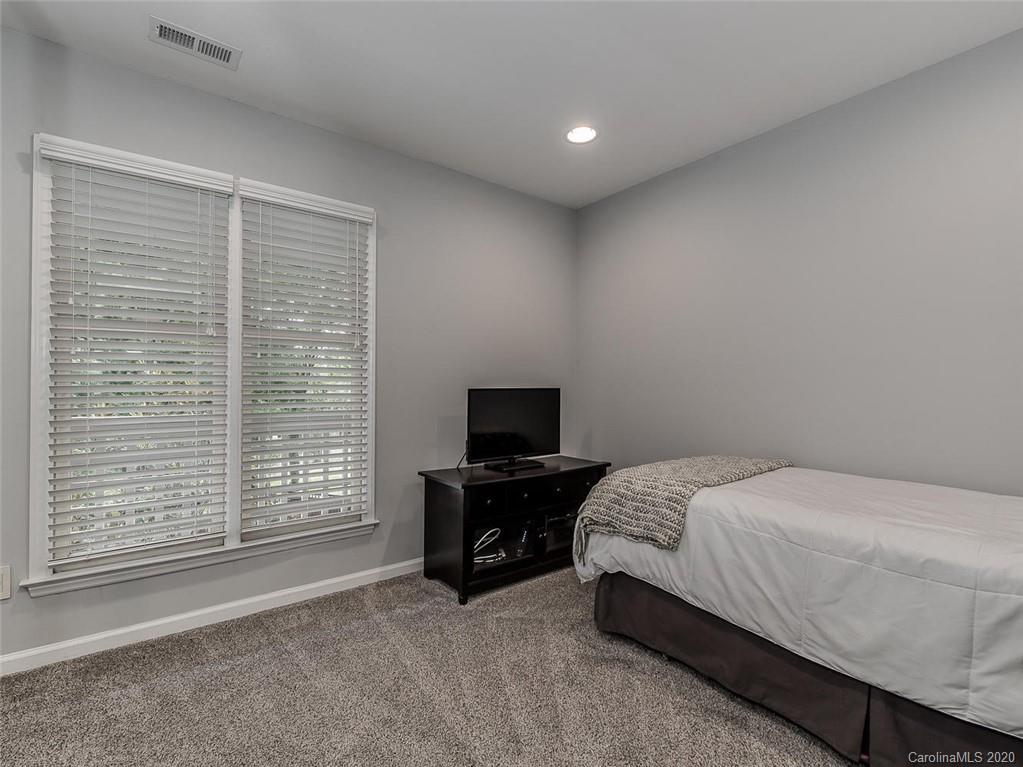 222 Queens Road, Unit 54 Charlotte, NC 28204 - Photo 15 of 18 a bedroom with a bed and a television
