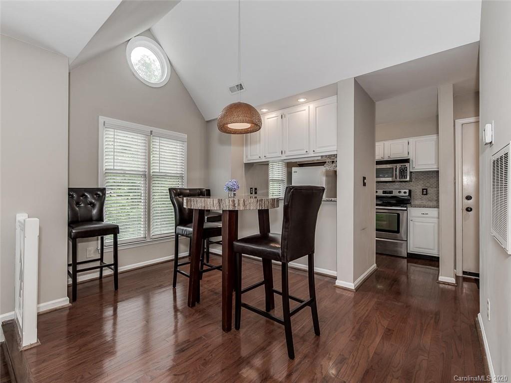 222 Queens Road, Unit 54 Charlotte, NC 28204 - Photo 7 of 18 a view of a dining room with furniture and wooden floor