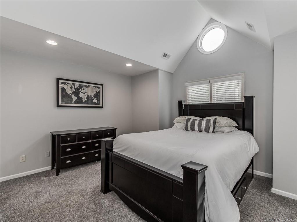 222 Queens Road, Unit 54 Charlotte, NC 28204 - Photo 10 of 18 a bedroom with a bed and a piano