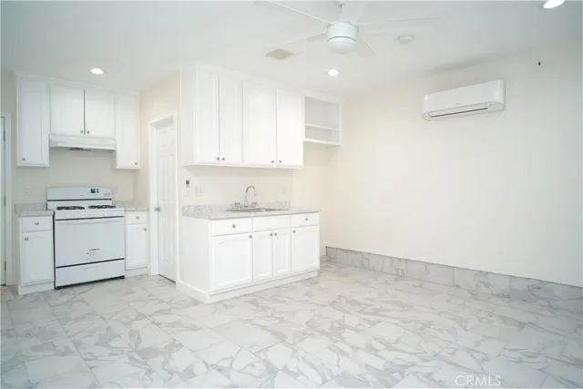 a room with white cabinets and white appliances