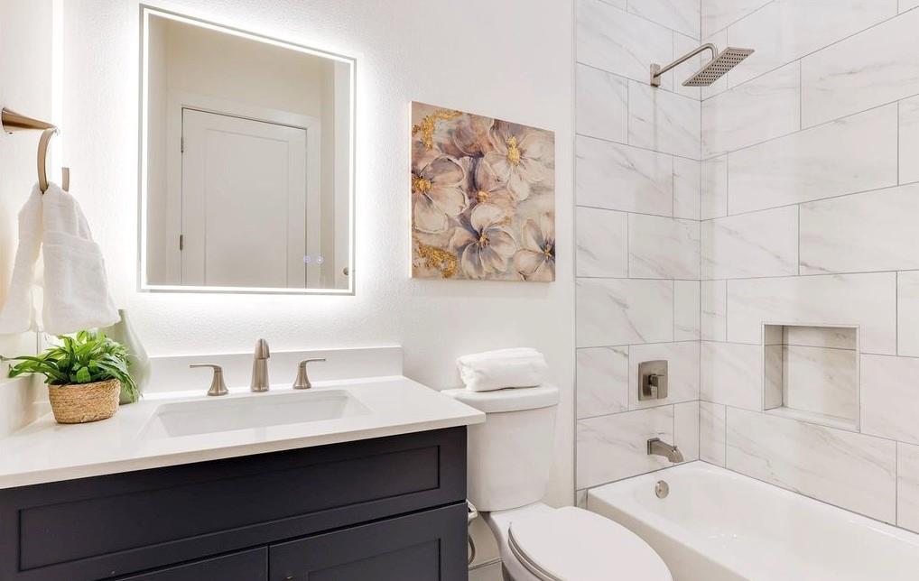 1902 North Carroll Avenue, Unit 102 Dallas, TX 75204 - Photo 20 of 29 a bathroom with a sink a toilet and shower