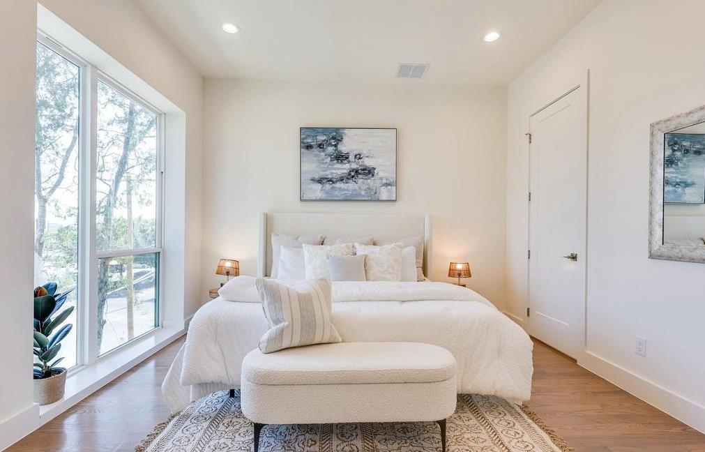 1902 North Carroll Avenue, Unit 102 Dallas, TX 75204 - Photo 24 of 29 a room with a bed and wooden floor