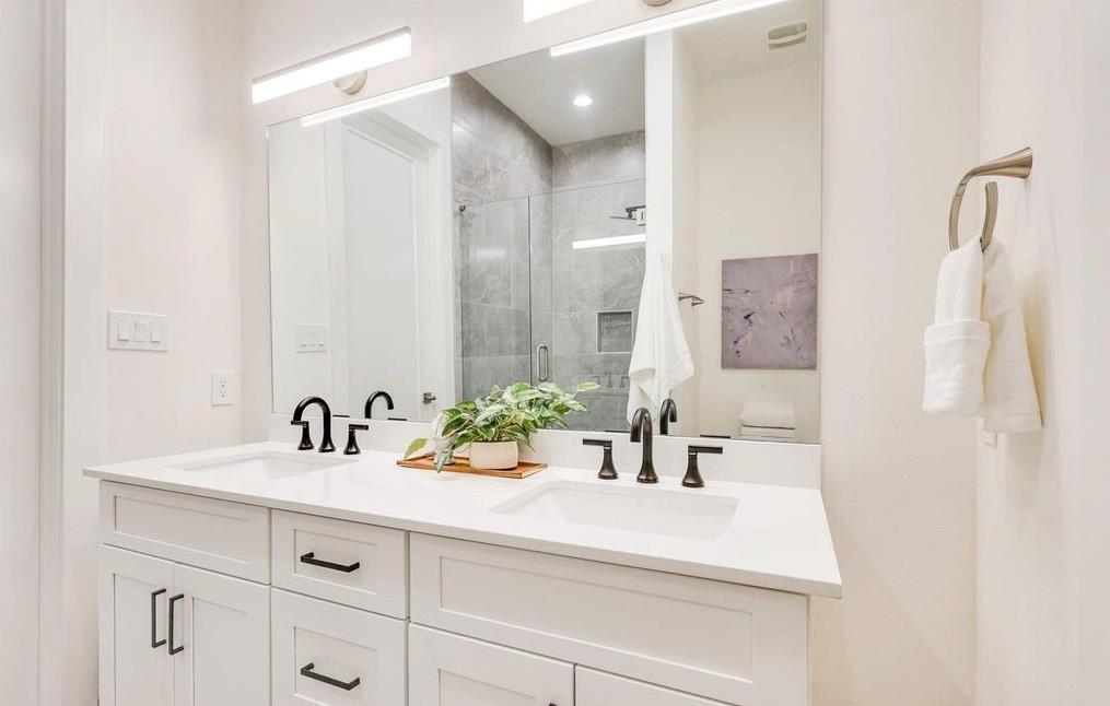 1902 North Carroll Avenue, Unit 102 Dallas, TX 75204 - Photo 28 of 29 a bathroom with a sink and a mirror