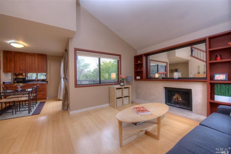 a living room with furniture a fireplace and a table