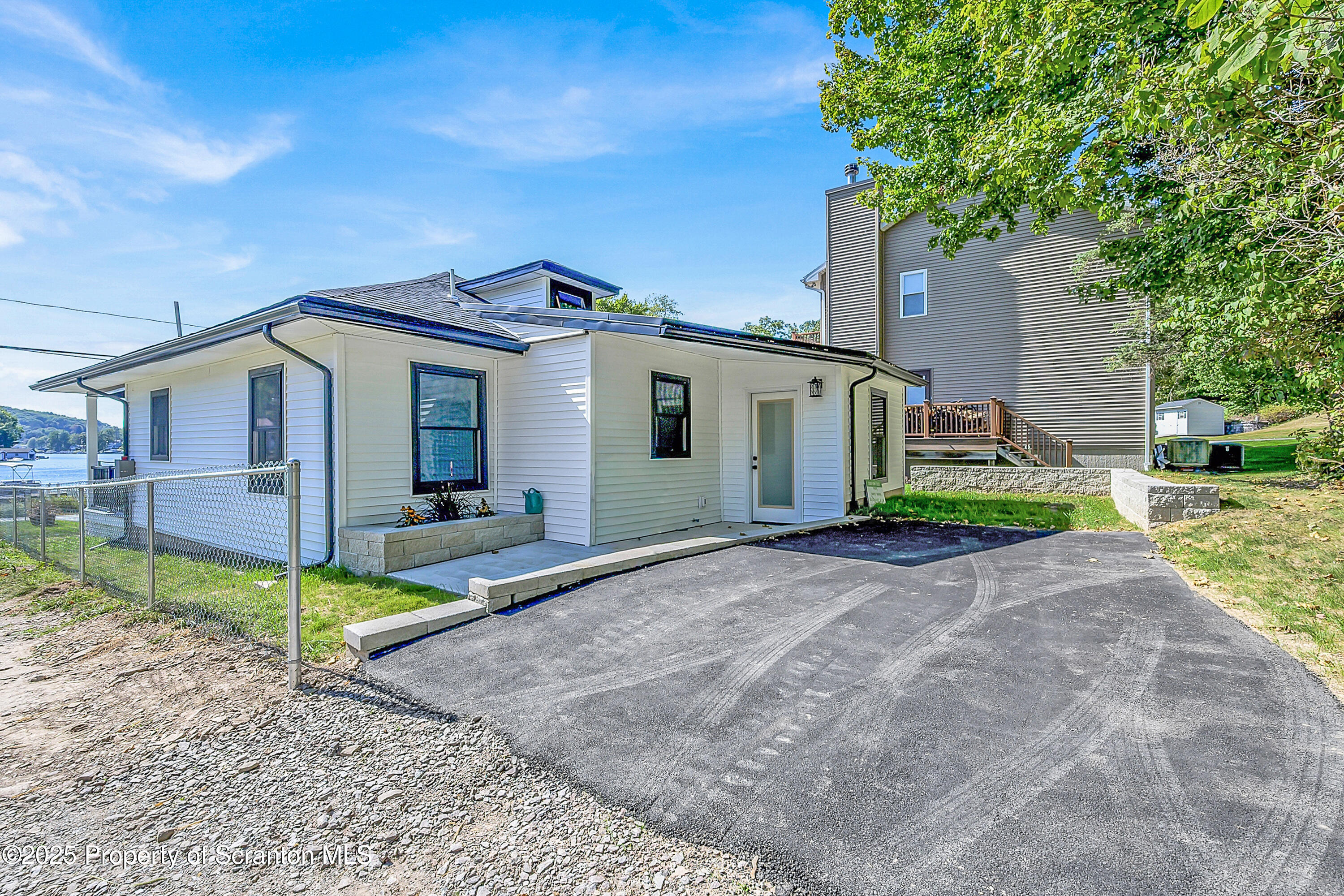 1262 Lake Road Lake Winola, PA 18419 - Photo 12 of 33 a view of a house with a small yard and large tree