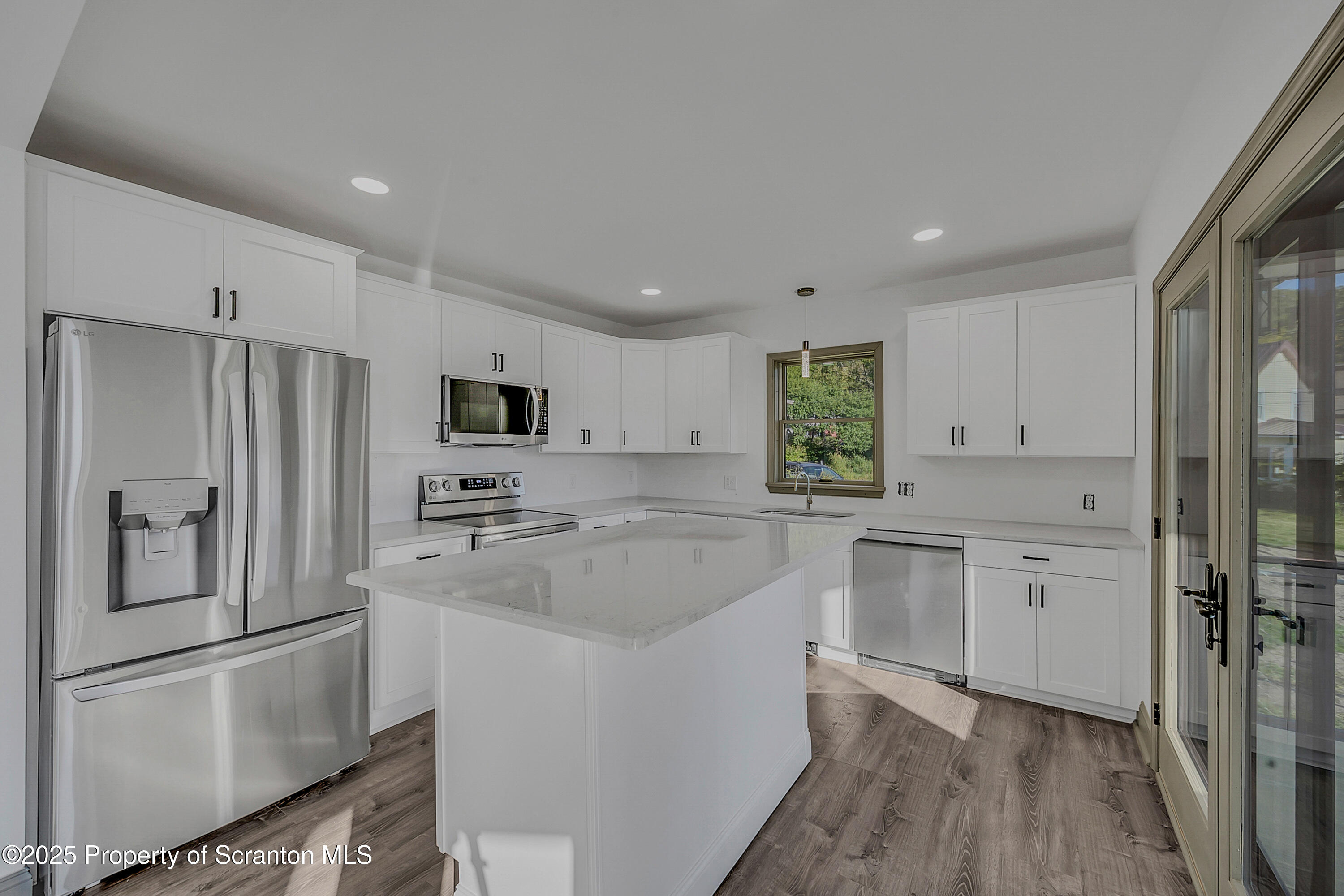 1262 Lake Road Lake Winola, PA 18419 - Photo 18 of 33 a kitchen with white cabinets and stainless steel appliances