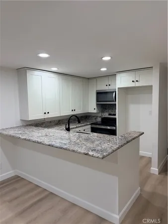 a view of an empty room with a fireplace and a floor to ceiling window