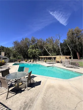 a view of a swimming pool with a table and chairs