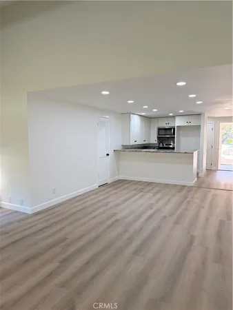a kitchen with granite countertop cabinets sink and window