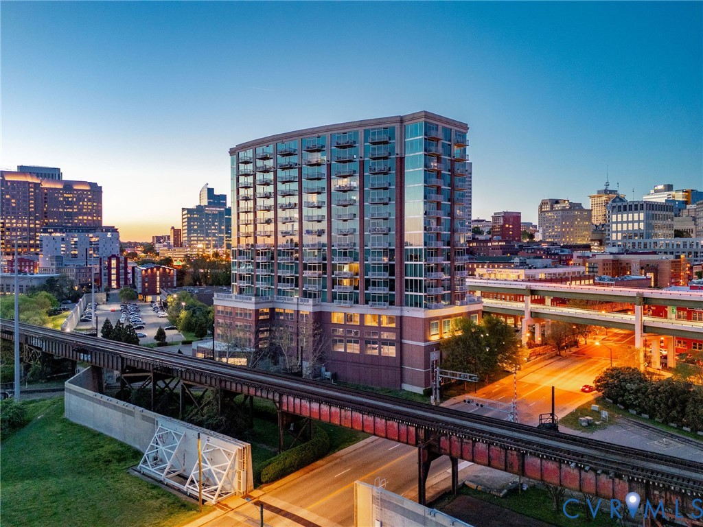 a balcony with tall buildings and ocean view