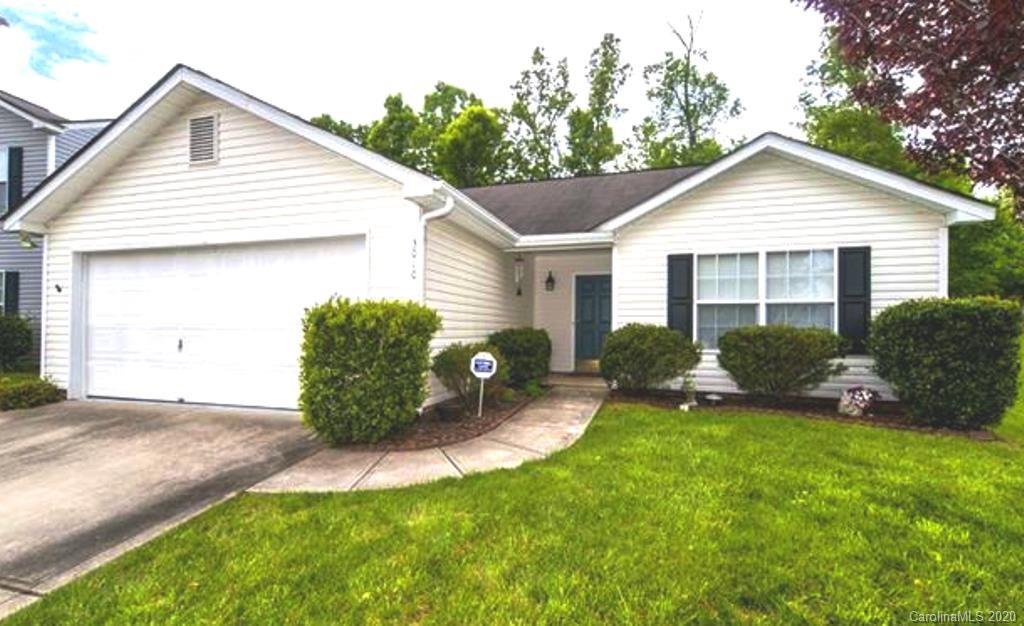 a view of a house with a yard and plants