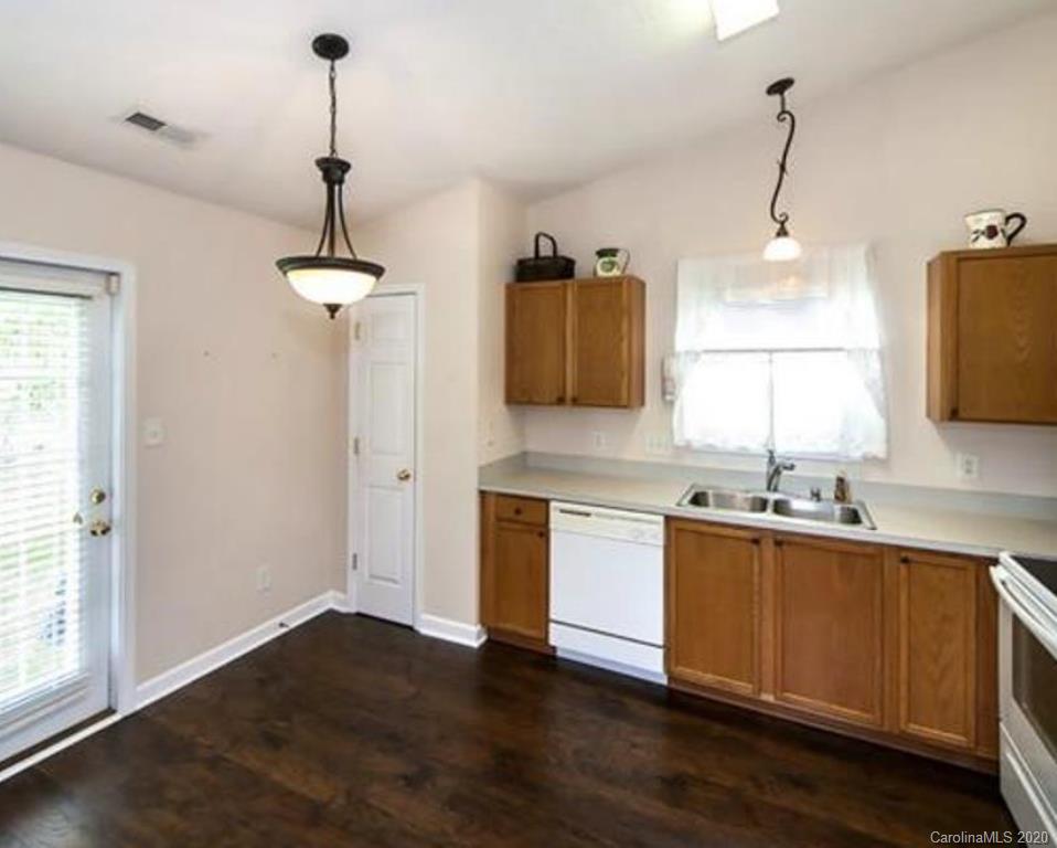 3010 Rugged Stone Way Charlotte, NC 28227 - Photo 2 of 4 a kitchen with stainless steel appliances granite countertop a sink a stove and a wooden floor