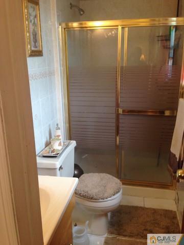 5 Ridge Road Edison, NJ 08817 - Photo 22 of 24 a bathroom with a sink a toilet and shower
