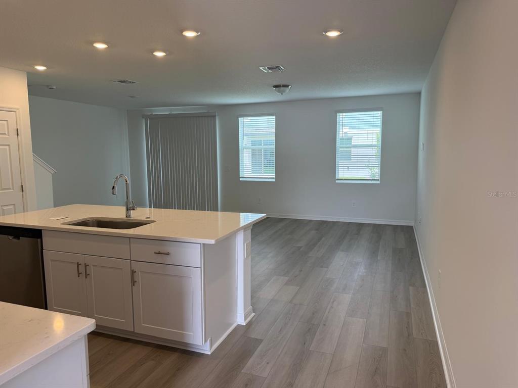 4264 Ranch House Road St. Cloud, FL 34772 - Photo 5 of 34 a room with a sink cabinets and wooden floor