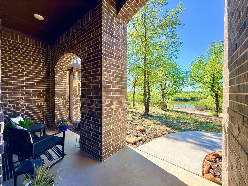 156 Cottongame Road Weatherford, TX 76088 - Photo 3 of 35 a view of a porch with couches and table and chairs next to yard
