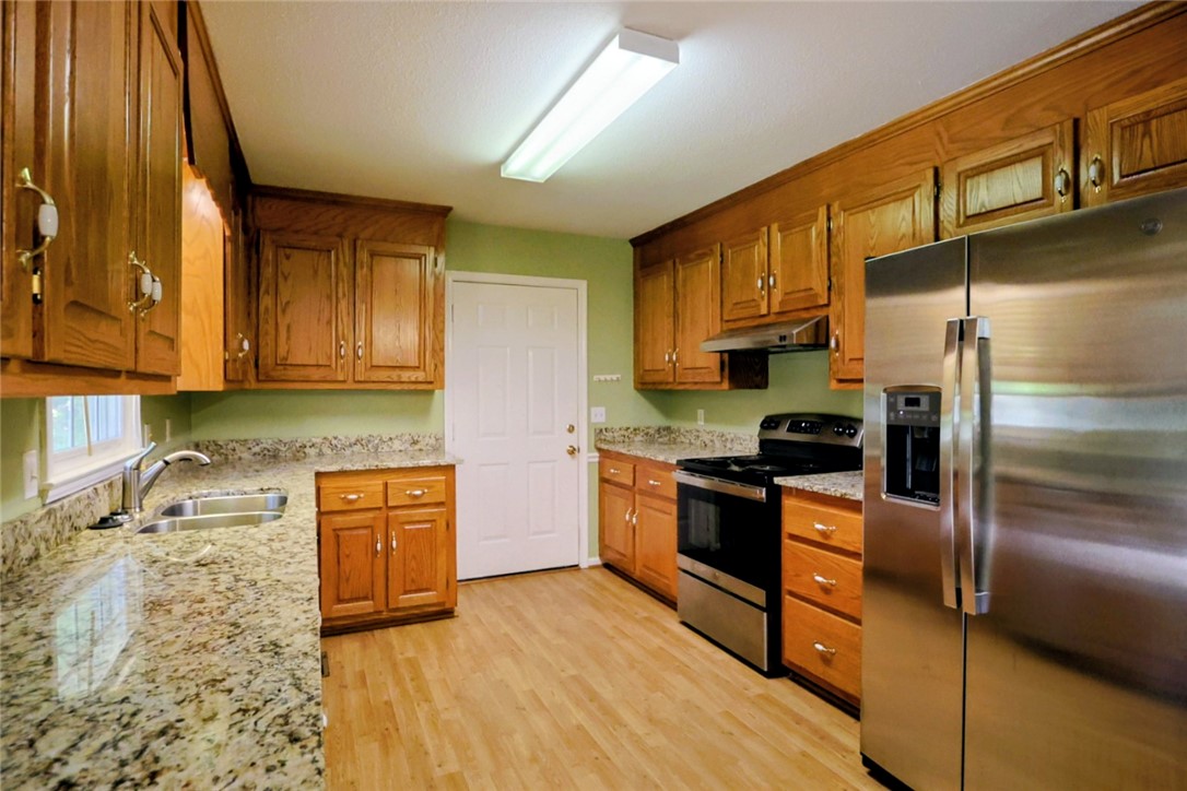 This functional kitchen offers ample cabinetry and counter space, perfect for culinary endeavors.