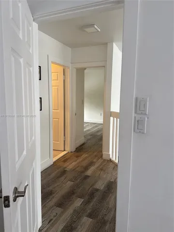 wooden floor with a bathroom