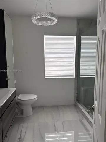 a bathroom with a toilet sink and a shower