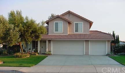 2197 West Dawnview Drive Rialto, CA 92377 - Photo 1 of 1 a front view of a house with a garden and trees