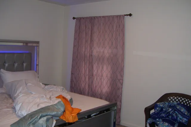 a bedroom with a bed and a window