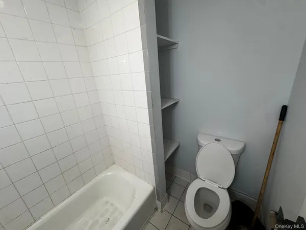 a white toilet sitting next to a white sink