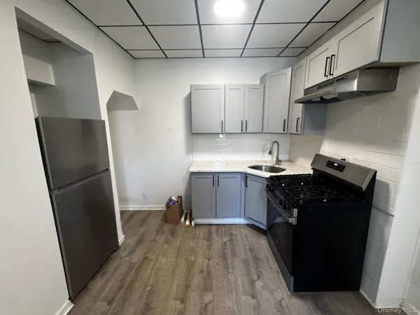 a kitchen with a refrigerator and a sink