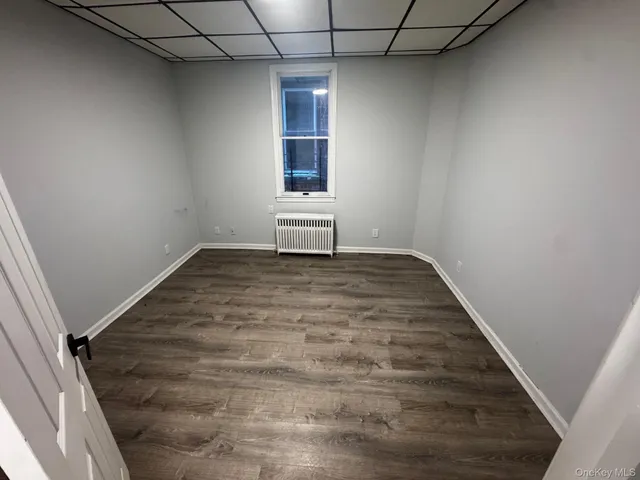 a view of a room with wooden floor and windows