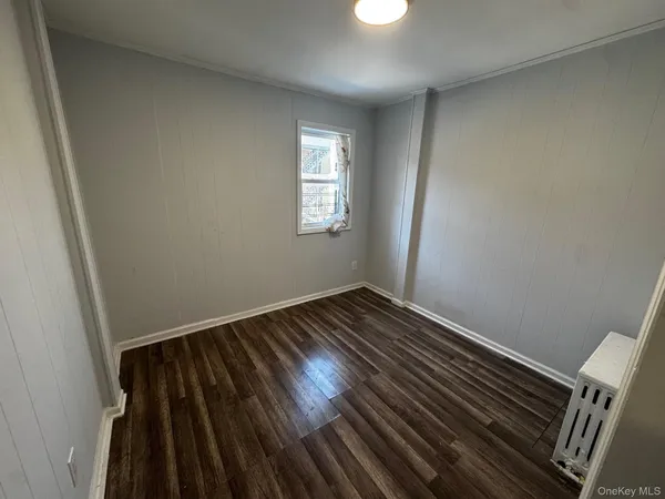 a view of an empty room and wooden floor