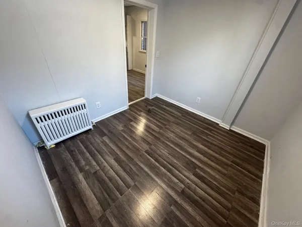a view of a room with wooden floor