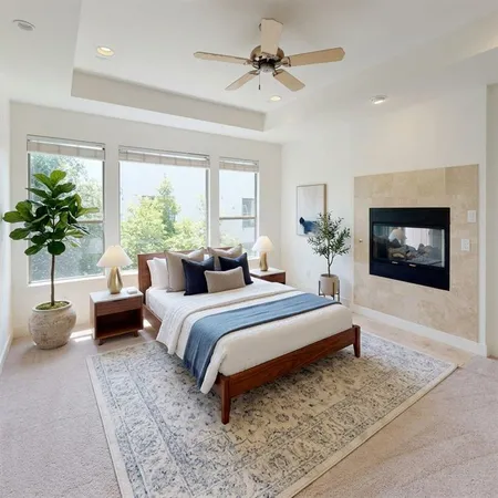 a bedroom with a bed couch and potted plant