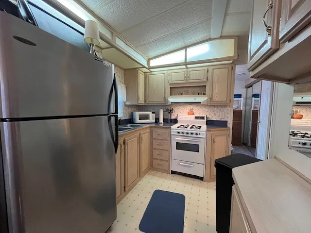 a kitchen with stainless steel appliances a refrigerator and a stove