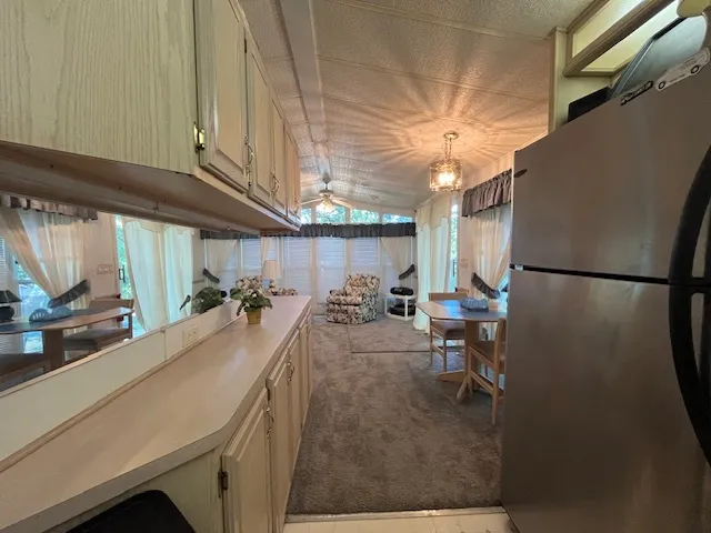 a kitchen with stainless steel appliances granite countertop a refrigerator a sink and a stove