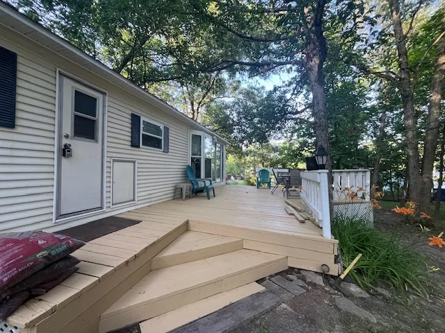 a view of a patio with table and chairs and wooden floor