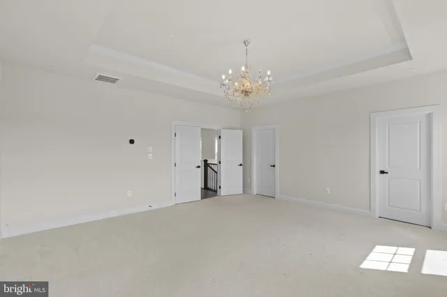a view of a chandelier and closet in a room
