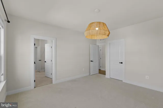 a view of room and chandelier fan