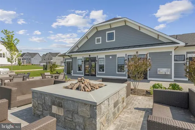 a living room with furniture and kitchen area