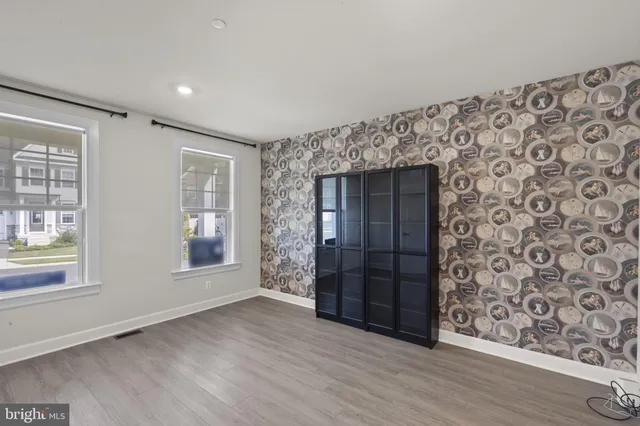 an empty room with windows and closet