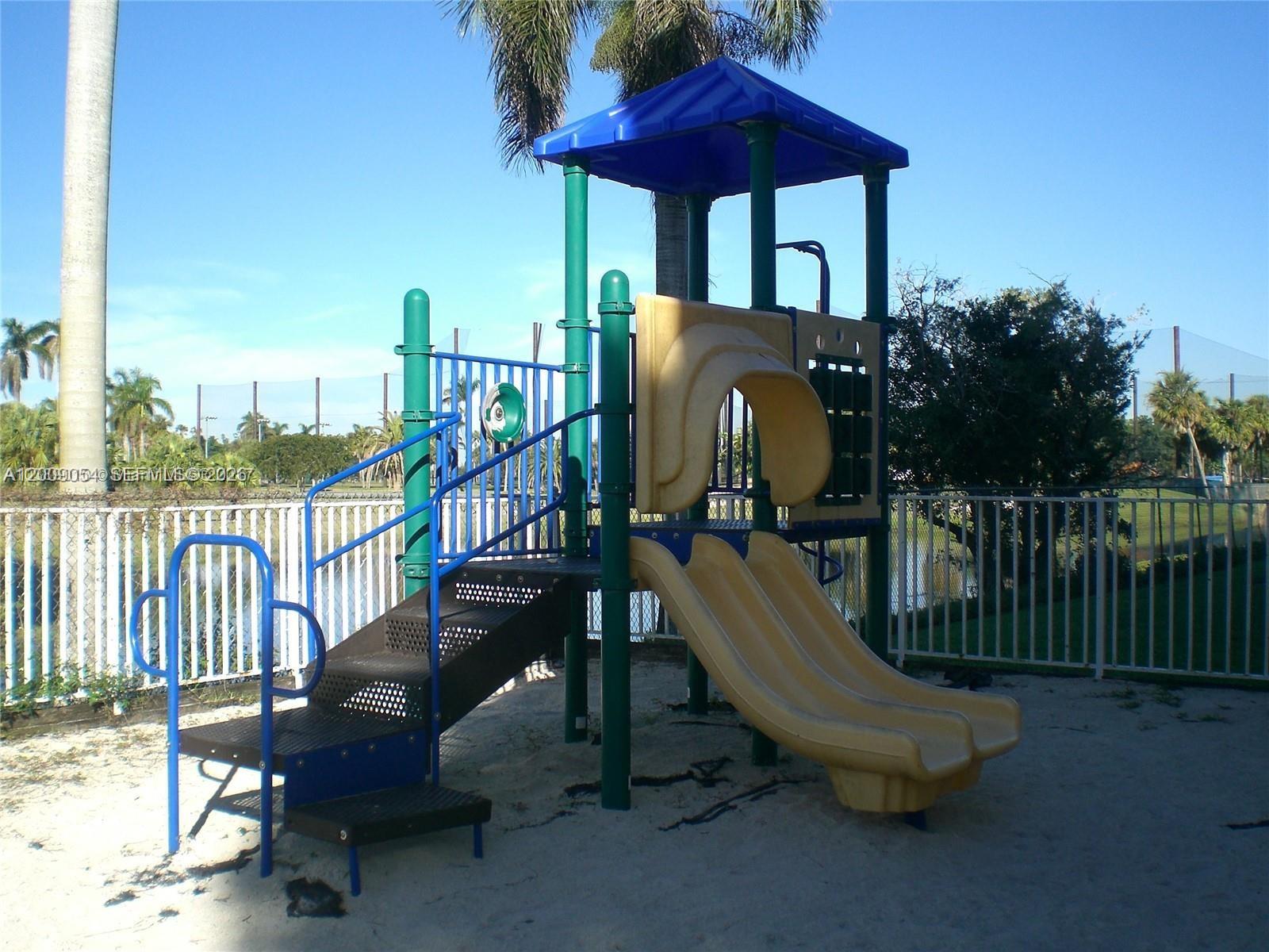 6955 Northwest 186th Street, Unit F209 Hialeah, FL 33015 - Photo 13 of 14 a view of a swimming pool with a lounge chairs
