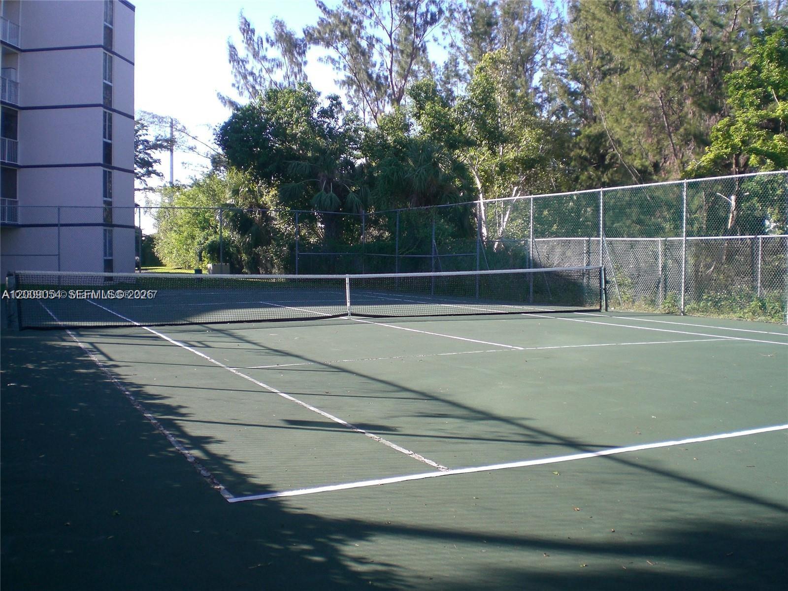 6955 Northwest 186th Street, Unit F209 Hialeah, FL 33015 - Photo 14 of 14 a view of a tennis court