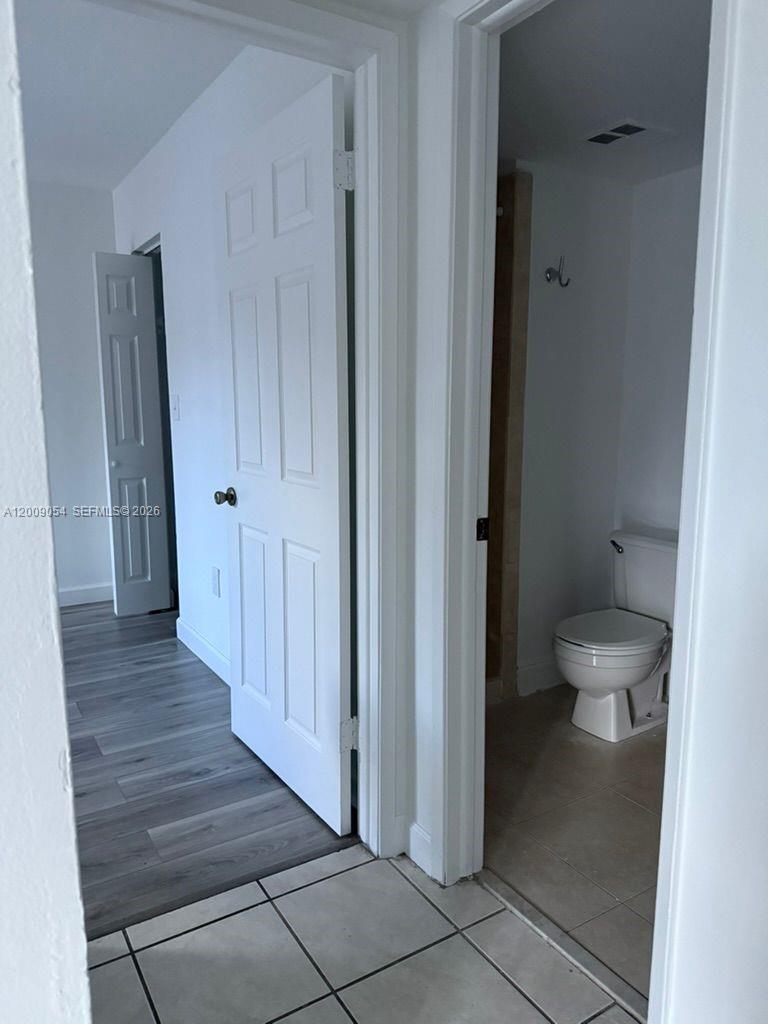 6955 Northwest 186th Street, Unit F209 Hialeah, FL 33015 - Photo 8 of 14 a bathroom with a toilet and a shower