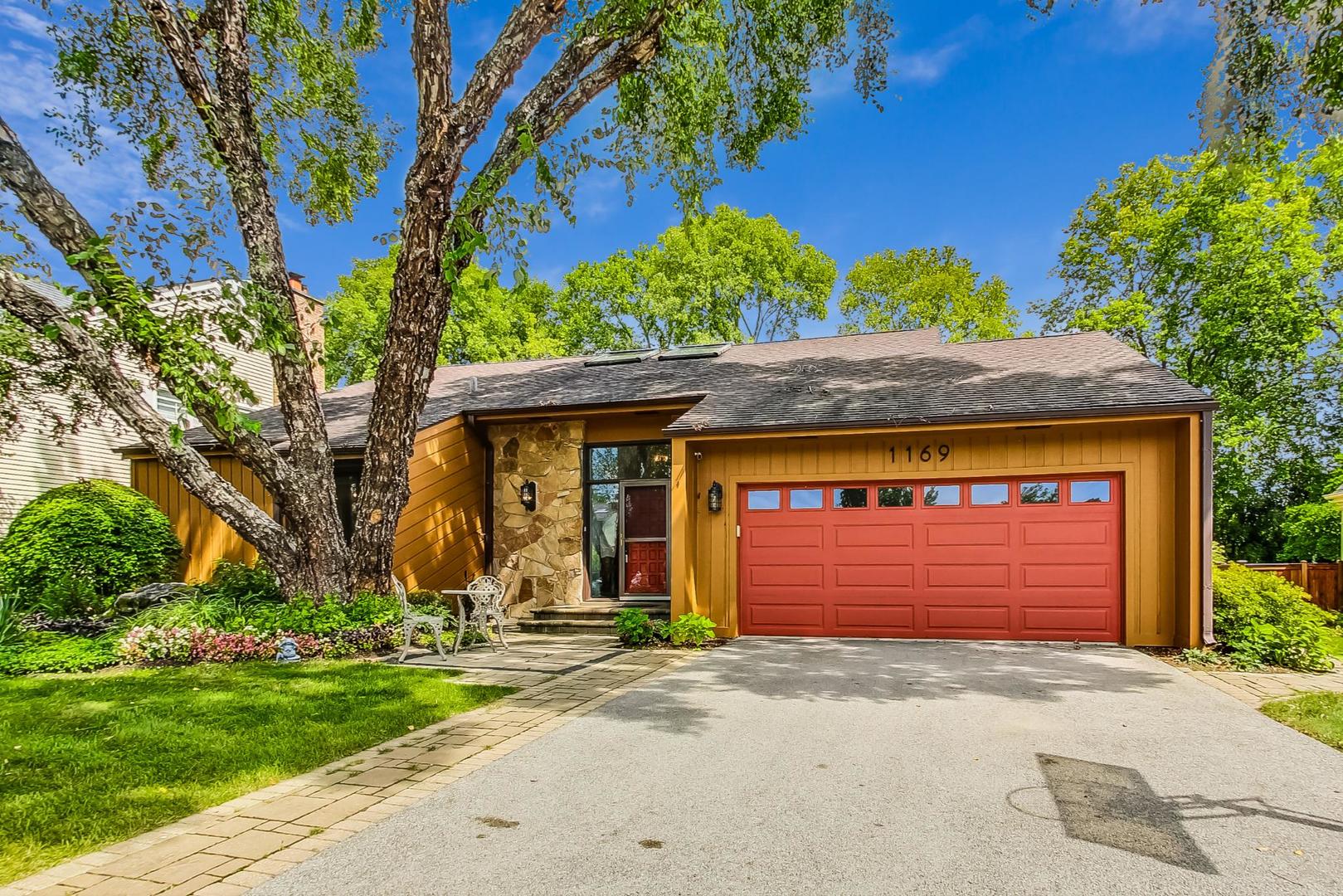 1169 Brighton Road Naperville, IL 60563 - Photo 1 of 54 a front view of a house with a yard and garage