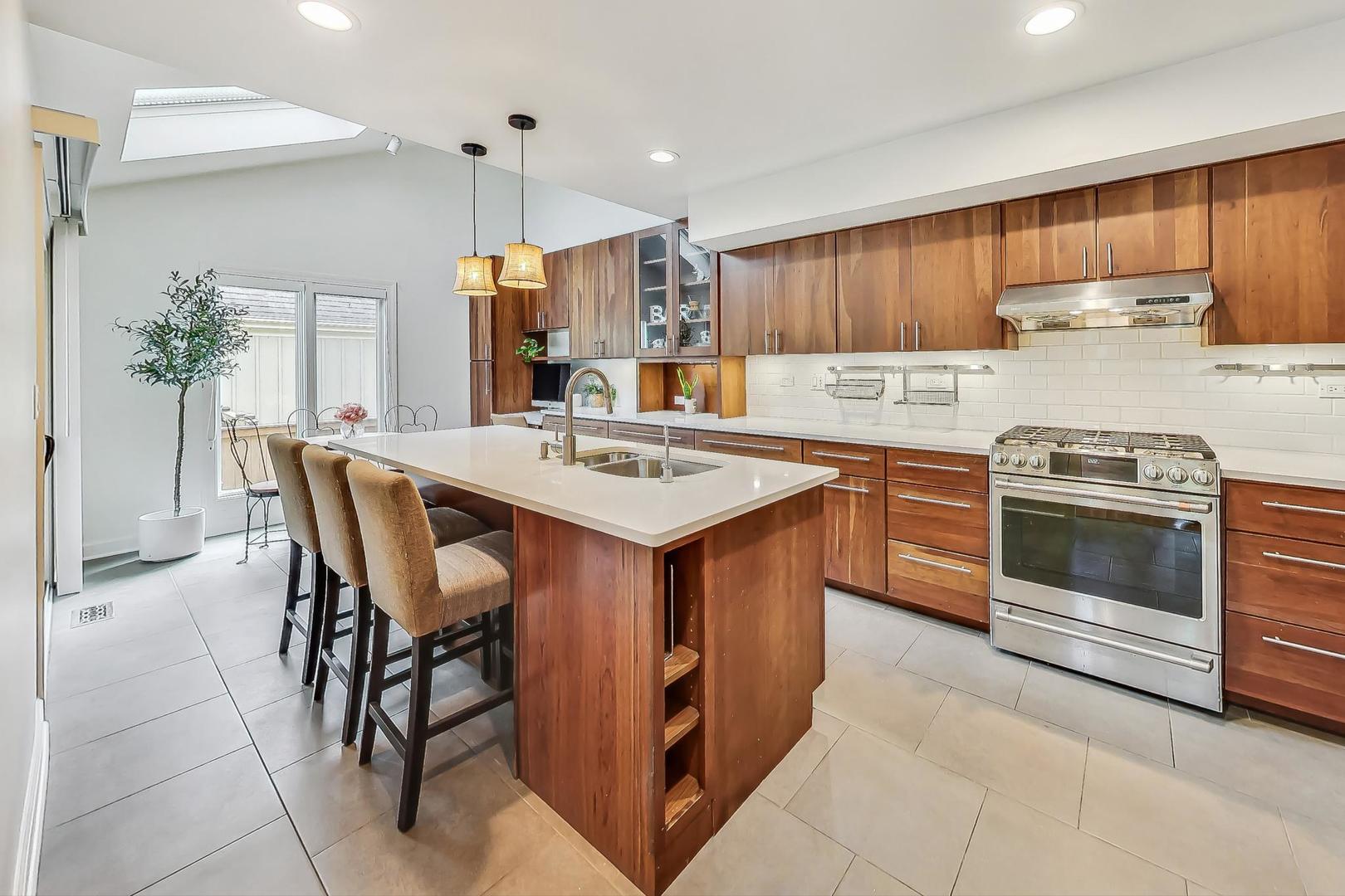 1169 Brighton Road Naperville, IL 60563 - Photo 12 of 54 a kitchen with a stove a refrigerator and a dining table
